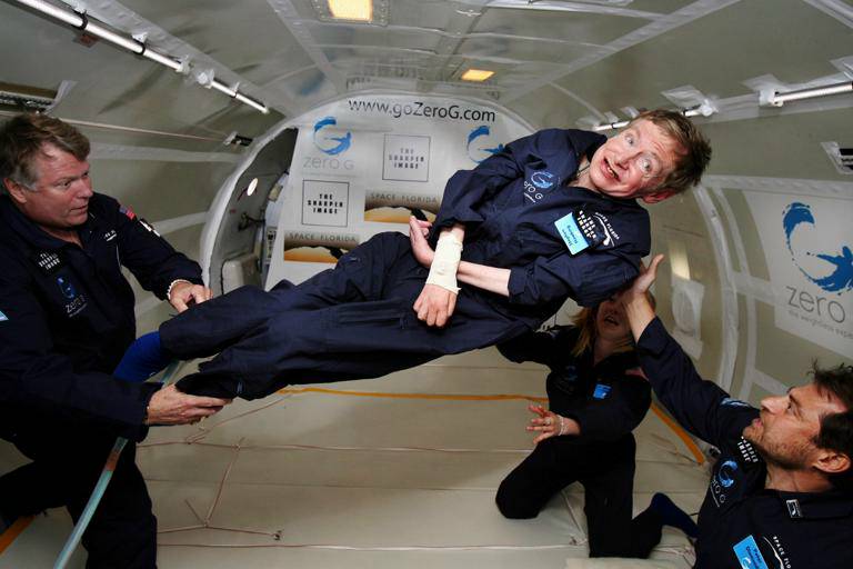 Noted physicist Stephen Hawking (center) enjoys zero gravity during a flight aboard a modified Boeing 727 aircraft owned by Zero Gravity Corp. (Zero G). Hawking, who suffers from amyotrophic lateral sclerosis (also known as Lou Gehrig's disease) is being rotated in air by (right) Peter Diamandis, founder of the Zero G Corp., and (left) Byron Lichtenberg, former shuttle payload specialist and now president of Zero G. Kneeling below Hawking is Nicola O'Brien, a nurse practitioner who is Hawking's aide. At the celebration of his 65th birthday on January 8, 2007, Hawking announced his plans for a zero-gravity flight to prepare for a sub-orbital space flight in 2009 on Virgin Galactic's space service. /Author: Jim Campbell/Aero-News Network/ 